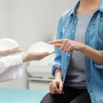 Woman choosing between two implants at a doctor's office