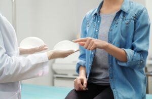 Woman choosing between two implants at a doctor's office